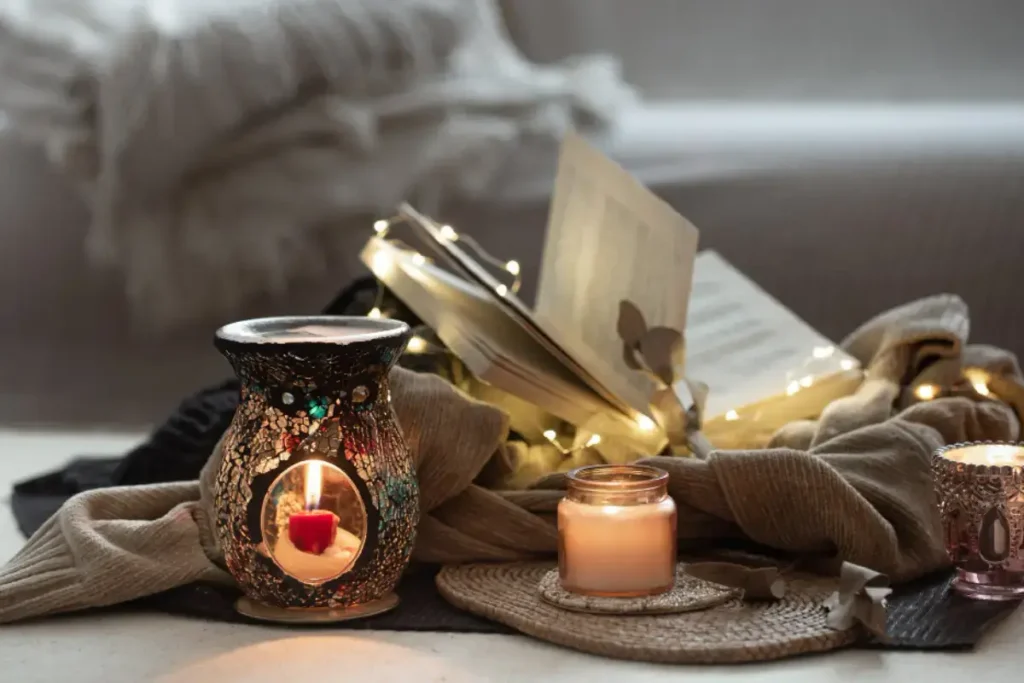 a small speaker beside candles or a cozy setup